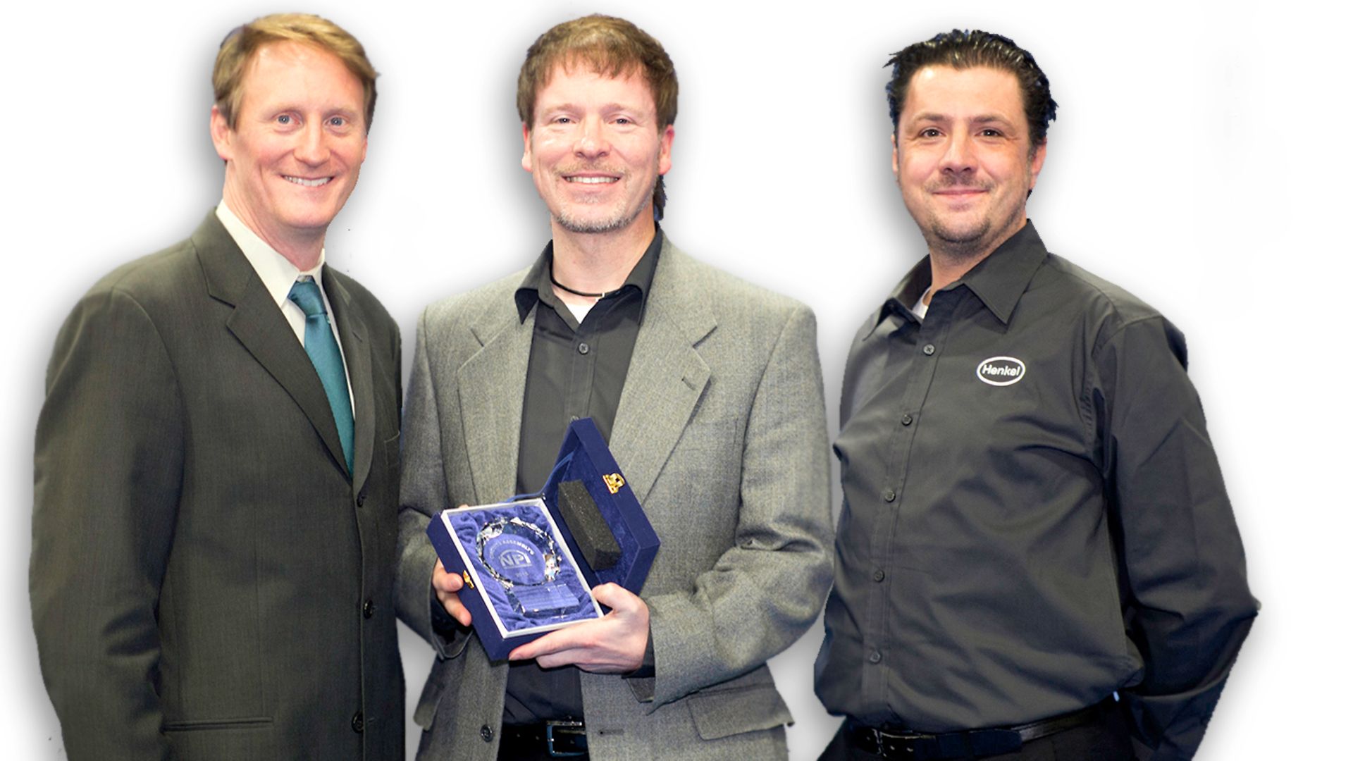 Henkel’s Dr. Mark Currie (center) and Ian Wilding (right) accept Loctite GC 10’s NPI Award